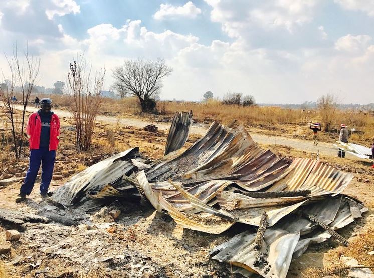 Nathal Basemlambeli stands next to his demolished shack in Old Brakpan township after police removed 300 shacks from the area on Tuesday.