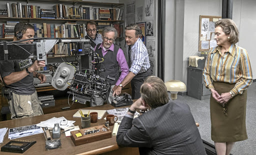 Behind the scenes of 'The Post'. Steven Spielberg works with Tom Hanks as Meryl Streep looks on from the side.