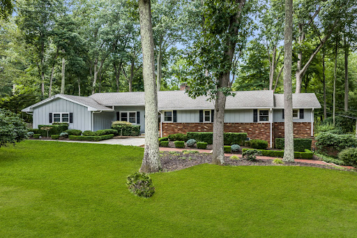 Modern house surrounded by lush trees in this luxury house for sale in Colts Neck ($1,250,000)