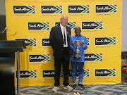 Johannes Mosehla receives his award for oldest finisher from Comrades Marathon Association vice-chairman Les Burnard. 