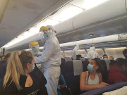 Officials screening passengers on the flight. 