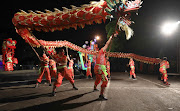 The Chinese community of Cape Town  perform a dragon dance during the  Cape Town Carnival.