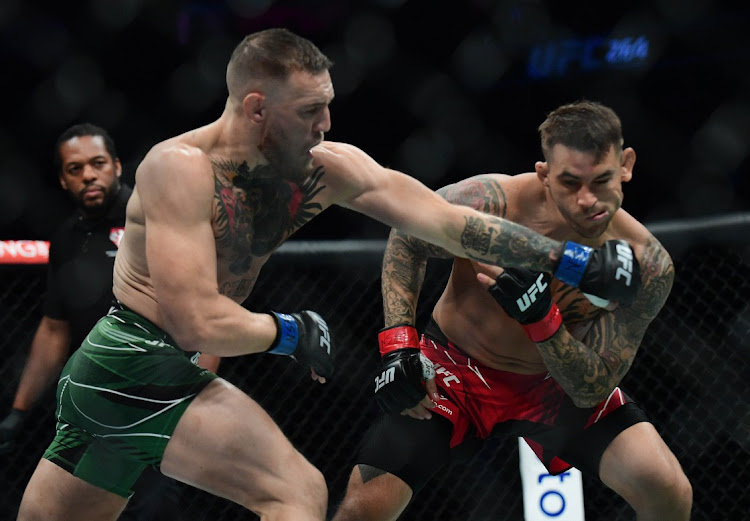 Conor McGregor hits Dustin Poirier during UFC 264 at T-Mobile Arena on July 10, 2021, Las Vegas, Nevada