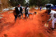 Friends and family help bury Osvaldo Minegen, 11, at the West Park Cemetery in Johannesburg on Friday, August 7. Minegen was struck and killed by a car on the last day of July. 