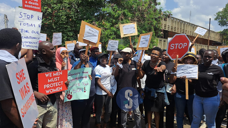 Kisumu residents holds a placard during to protest against the increased number of femicides experienced across the country on January 27, 2024