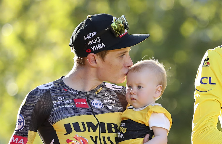 Second-placed finisher on the final stage of the Tour Jonas Vingegaard of Denmark and Jumbo - Visma holding his baby during the last stage trophy ceremony in Paris of the 108th Tour de France 2021, a flat stage of 108,4km from Chatou to Paris Champs-Elysees on July 18 2021.