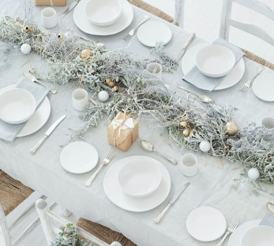 An all-white Christmas table setting.