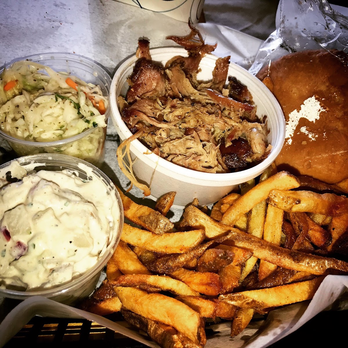 Pulled pork, GF bun, fries, coleslaw and potato salad