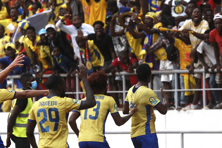 Adriano Yano of Petro Atletico is congratulated by teammates for scoring a goal against Mamelodi Sundowns during their Caf Champions League match at the 11 November Stadium in Luanda.