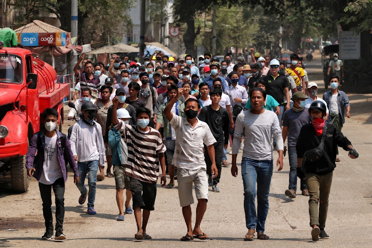 Anti-coup demonstrators gesture as they march in Nyaung-U, Myanmar March 17, 2021 in this image obtained by