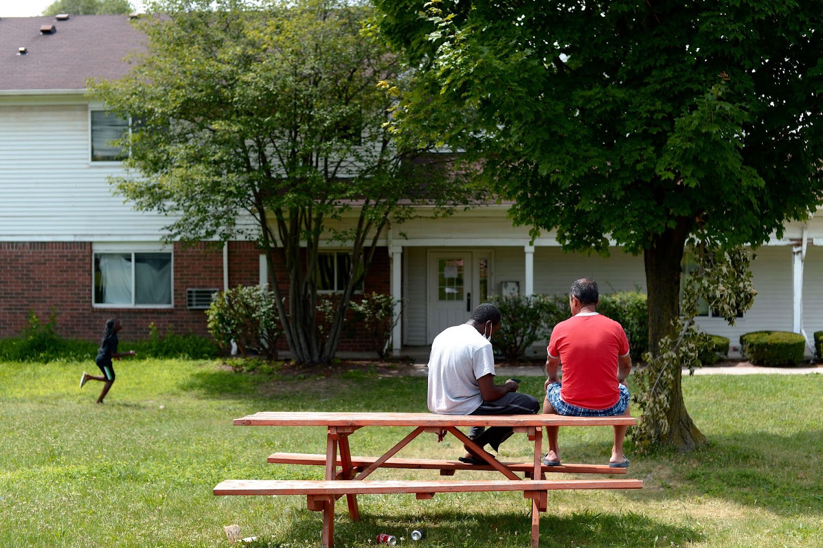 Image of people on a picnic table at Freedom House