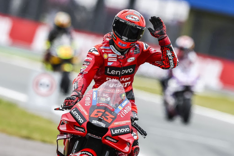 Francesco Bagnaia celebrates on his bike after setting the fastest time during MotoGP qualifying on June 25, 2022 at the TT circuit of Assen, Netherlands.