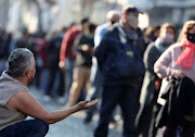 A man begs during the feast day of San Cayetano (Saint Cajetan), patron saint of labour and bread, at San Cayetano church in Buenos Aires, Argentina August 7, 2021. 