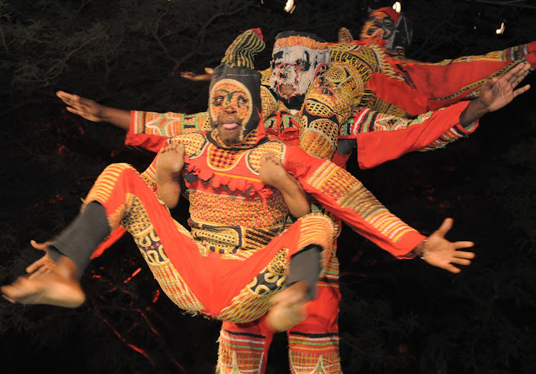 Dancers in appliqued masquerade costumes from the Ibo of Nigeria