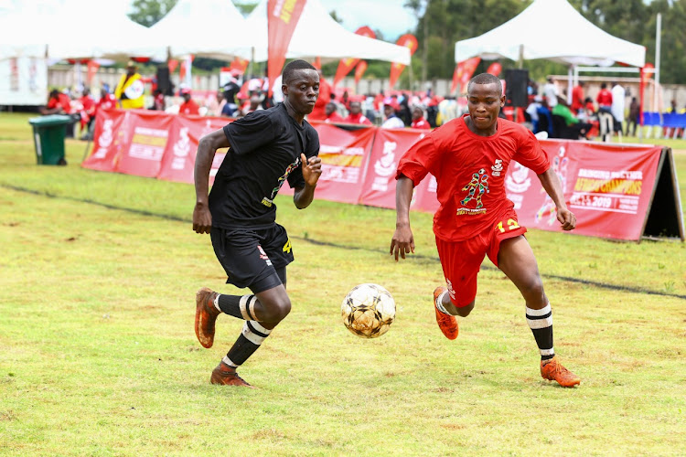 Kenya's Hamisi Hamisi (L) vies for the ball with Bele Innocent of Botswana