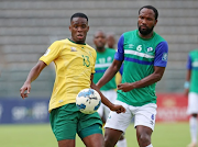 Bafana Bafana midfielder Sphephelo Sithole in a tussle for the ball with Lesotho defender Lisema Lebokollane during their preparation match at Lucas Moripe Stadium.