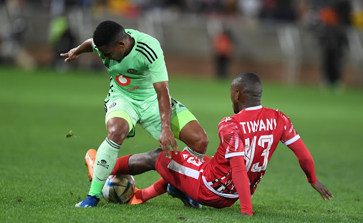 Thabiso Lebitso of Orlando Pirates is challenged by Asekho Tiwani of Sekhukhune United in the DStv Premiership match at Peter Mokaba Stadium in Polokwane on Saturday.