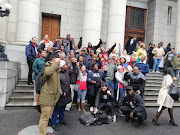 Members of Reclaim the City sing outside the Western Cape High Court after the court ruled in their favour.