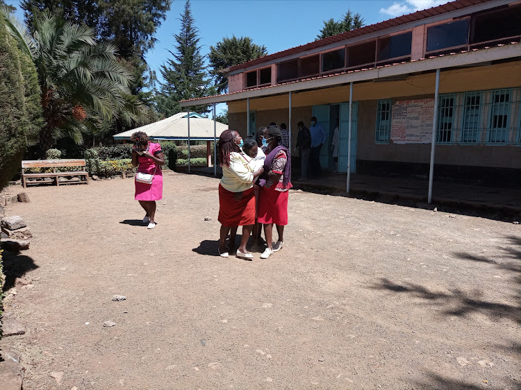 Paul Mburu's widow Mercy Njeri being comforted by friends after identifying his body at Nyahururu County Referral Hospital mortuary on Monday, December 14, 2020