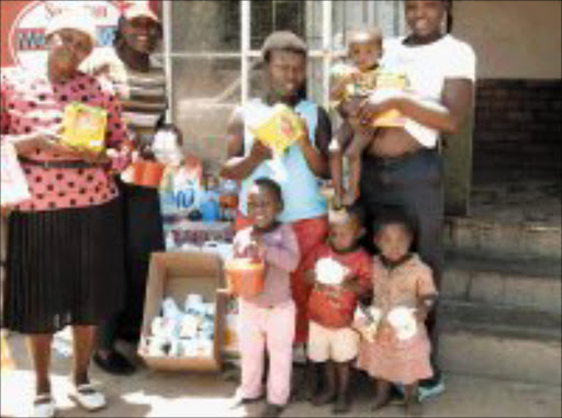 RELIEF: Lindi Obose, sedond from left, Sowetan's social responsibility mascot, and Paulina Makgamathe with six of her 23 grandchildren, sowetan gave the family food, crockery and other provisions. Pic. Nthabiseng Moreosele. © Sowetan.