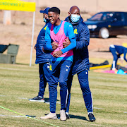 New Mamelodi Sundowns recruit Sifiso Ngobeni shares a light moment with senior coach Steve Komphela during a training session at the club's headquarters in Chloorkop on July 27 2021. 