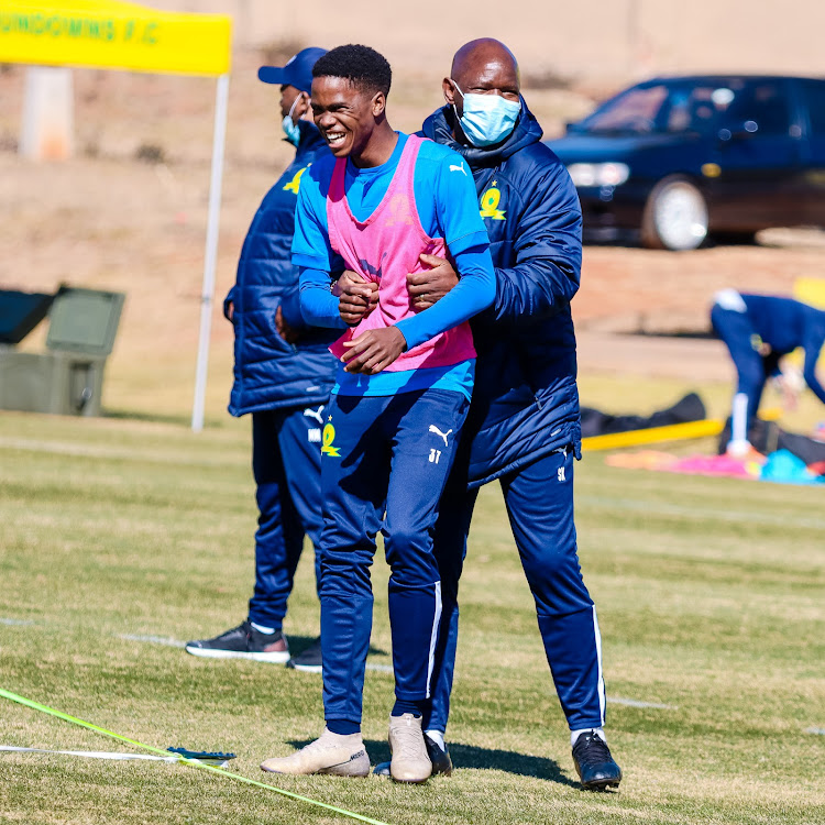 New Mamelodi Sundowns recruit Sifiso Ngobeni shares a light moment with senior coach Steve Komphela during a training session at the club's headquarters in Chloorkop on July 27 2021.