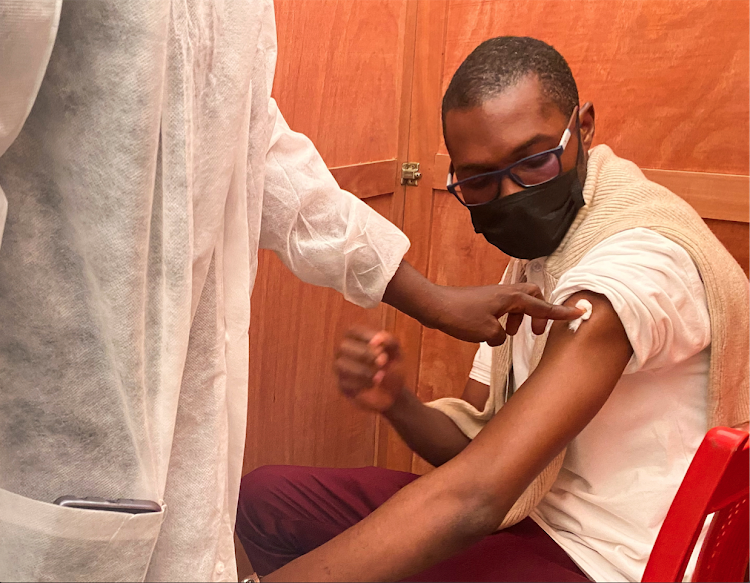 Franz Cedric Mbende, a football fan, receives vaccination against the coronavirus disease in Douala, Cameroon on December 29, 2021