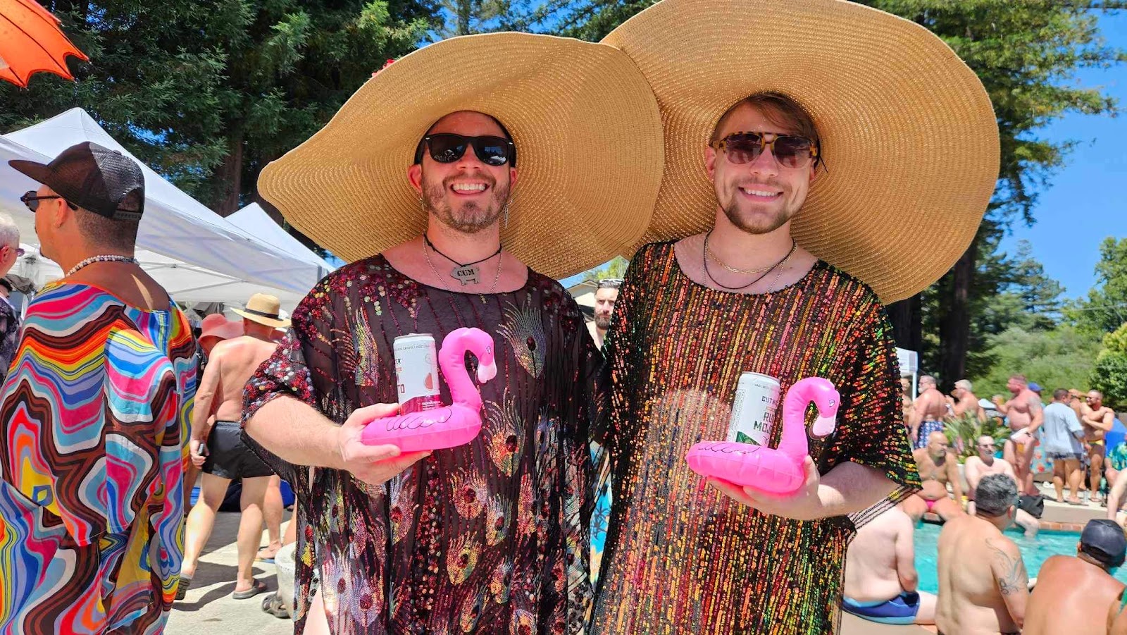two males swearing beach throws carrying flamingo beer cozies in big floppy sun hats at lazy bear week 2023