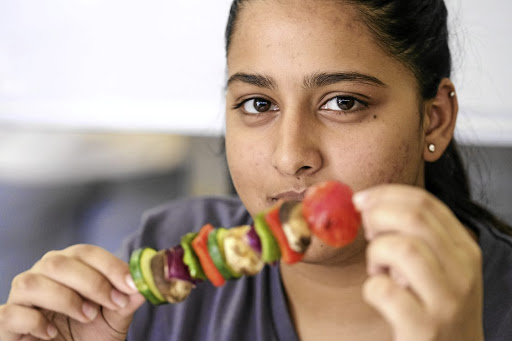 UJ student Tasneem Khan puts one of Food Lover's Market's vegetable kebabs to the taste test.