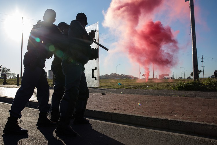 Police fire smoke grenades to disperse protesters in Bishop Lavis on Wednesday.