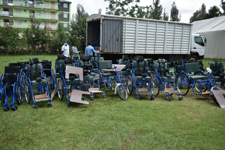 Wheelchairs being offloaded from a lorry.