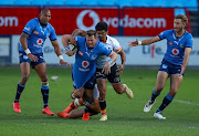 Ruan Combrink of the Blue Bulls is tackled by Ruan Pienaar (c) of the Free State Cheetahs during the Currie Cup match between  the two sides at Loftus Versfeld on August 28, 2021 in Pretoria