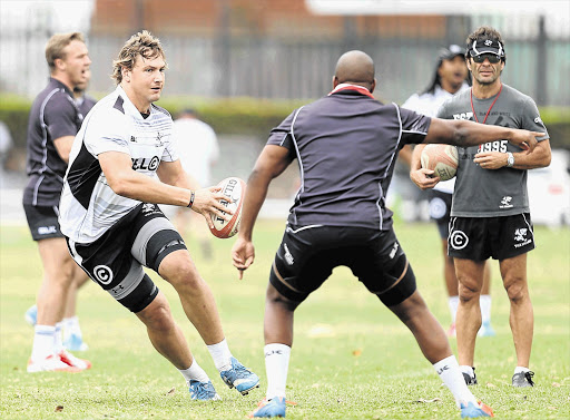 GO-GETTER: Etienne Oosthuizen tries to beat a man during a Sharks training session before tomorrow's Currie Cup semifinal at Ellis Park