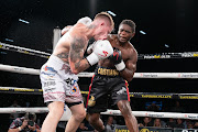 Referee Tony Nyangiwe stands behind a fallen Roarke Knapp against Cristiano Ndombassy on Saturday night.