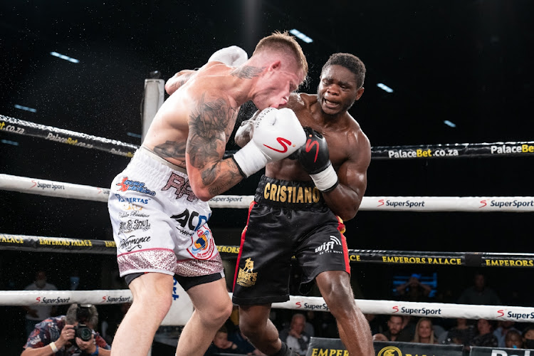 Referee Tony Nyangiwe stands behind a fallen Roarke Knapp against Cristiano Ndombassy on Saturday night.