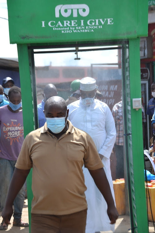 Kitui Senator Enoch Wambua walks out of a public sanitisation booth in Kitui on Sunday