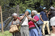 TRAGEDY STRIKES AGAIN: Grieving friends outside the home of Richmond deputy mayor Thandazile Phoswa, who was killed there on Sunday night. Police said a man was being questioned in connection with the killing.