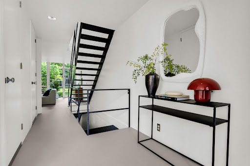 Modern entryway with black metal staircase - Luxury house for sale in Detroit, 3 bedrooms