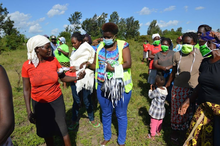 Some of the residents receive face masks from Jungle Foundation officials.