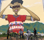 Social 'activator' Siyabonga Mbaba hopes his cycle tours through Khayelitsha will help visitors see the township in a new light - as a place of creativity and innovation.  Mural created by Breeze Yoko. 