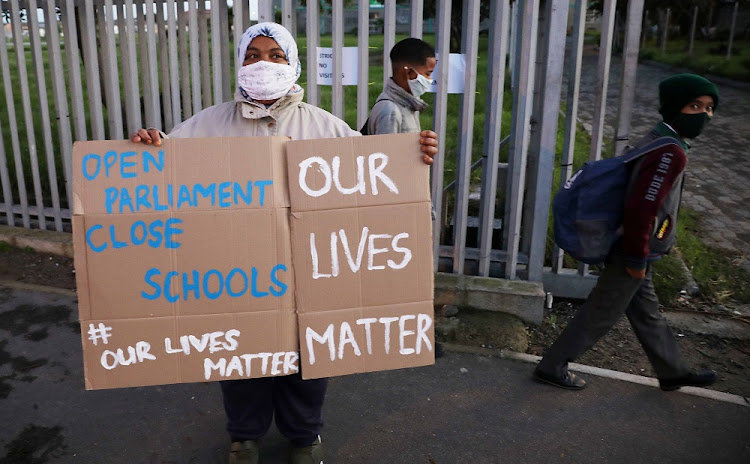 Cape Flats mom Farieda Abrahams, from Hanover Park, outside her son’s school, protesting against its opening. Pupil absenteeism has been high since schooling started again.