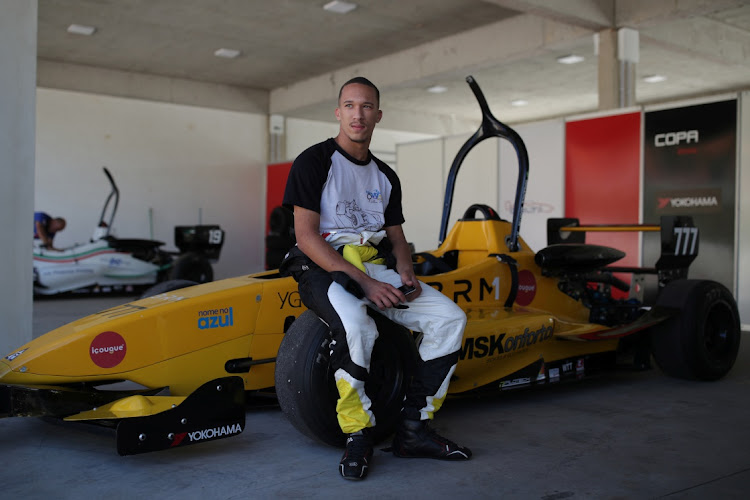 Driver Wallace Martins,18, sits on a tyre of his car during the Formula Delta in Lima Duarte, state of Minas Gerais, Brazil on November 5, 2021