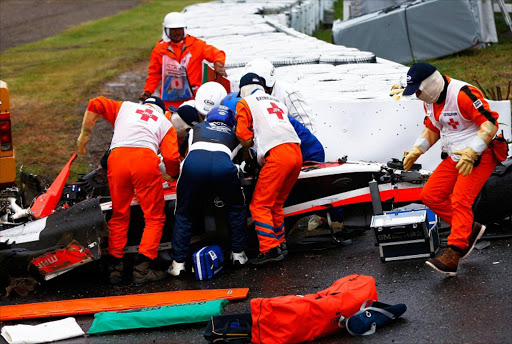 Jules Bianchi of France and Marussia receives urgent medical treatment after crashing during the Japanese Formula One Grand Prix at Suzuka Circuit. Picture Credit: Getty Images