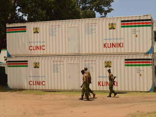 Police officers patrols around some the 100 portable container clinics at the NYS yard in Mombasa, November 11, 2016. /JOHN CHESOLI