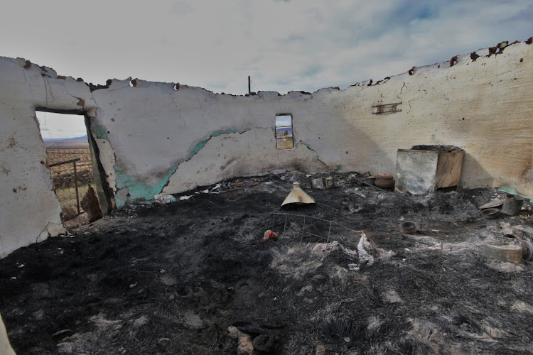 The remains of a home where the occupants were killed before it was burned down in Mdeni.
