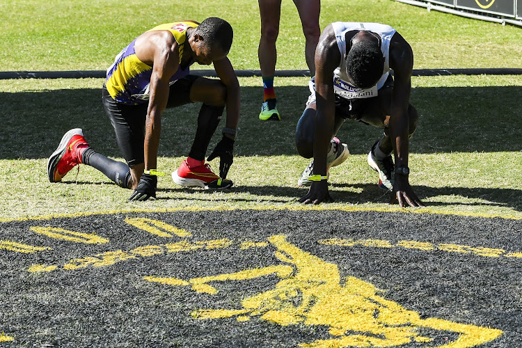 Runners complete the 2023 Comrades at the Kingsmead finish.