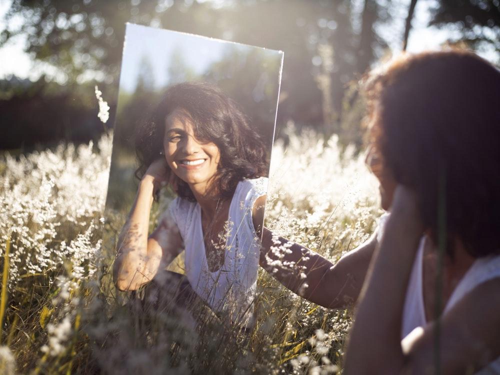 Woman Looking At A Mirror