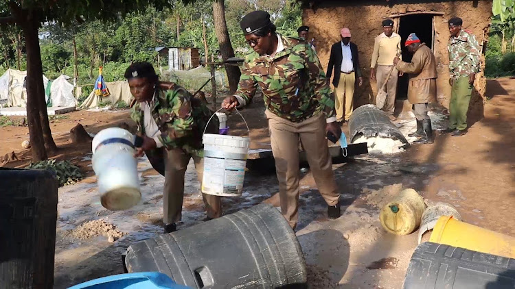 Chiefs destroying illicit brew at Munyali area, Kanduyi Constituency in Bungoma County on Friday.