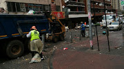 Pikitup workers clean he mess left by Jozi@work protesters in Hillbrow.