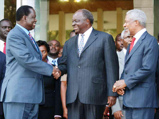 Former UN secretary general Kofi Anan watches as Opposition leader Raila Odinga and President Mwai Kibaki shake hands outside Harambee House, after brokering a peace deal in 2008 following post-election violence. /FILE